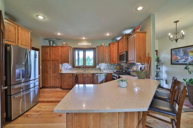 23369 330th St, Sebeka, MN 56477 - kitchen featuring appliances with stainless steel finishes, a sink, a peninsula, tasteful backsplash, and recessed lighting