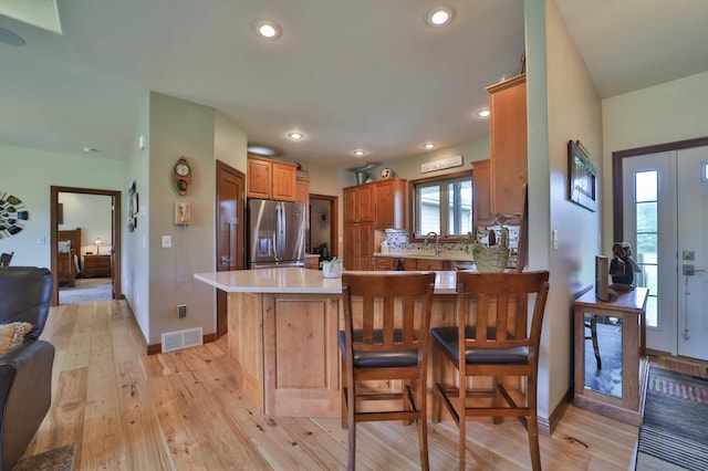 23369 330th St, Sebeka, MN 56477 - kitchen featuring stainless steel fridge, light wood-style floors, light countertops, a peninsula, and baseboards