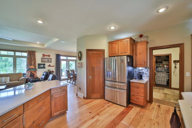 23369 330th St, Sebeka, MN 56477 - kitchen featuring stainless steel fridge with ice dispenser, brown cabinets, open floor plan, light countertops, and light wood-style floors