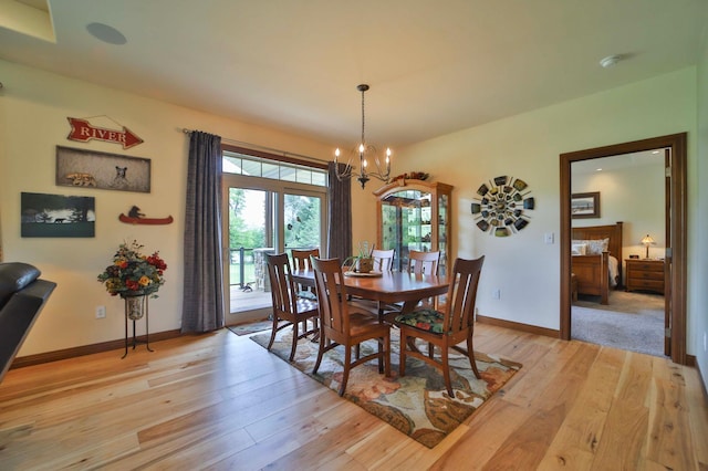 23369 330th St, Sebeka, MN 56477 - dining area featuring a chandelier, light wood finished floors, healthy amount of natural light, and baseboards