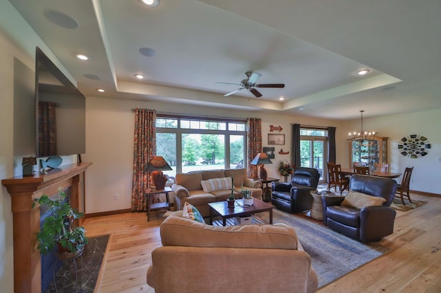 23369 330th St, Sebeka, MN 56477 - living room featuring a raised ceiling, light wood-type flooring, baseboards, a ceiling fan, and recessed lighting
