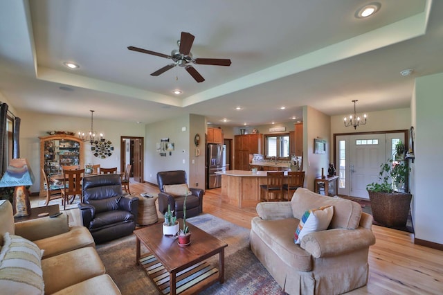 23369 330th St, Sebeka, MN 56477 - living room featuring a chandelier, light wood finished floors, a raised ceiling, ceiling fan, and recessed lighting