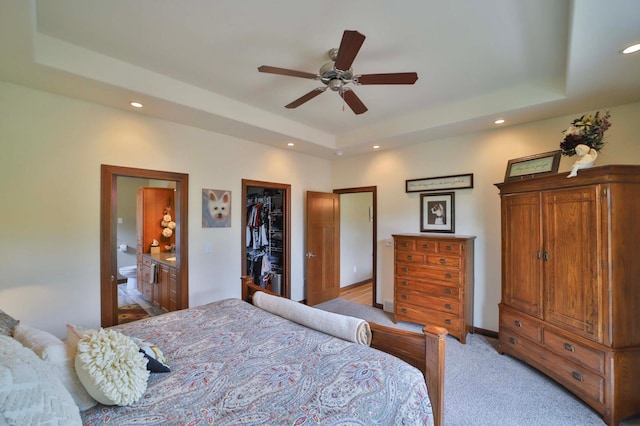 23369 330th St, Sebeka, MN 56477 - bedroom with a raised ceiling, recessed lighting, light colored carpet, a spacious closet, and ensuite bath
