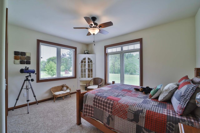 23369 330th St, Sebeka, MN 56477 - carpeted bedroom with multiple windows, baseboards, and ceiling fan