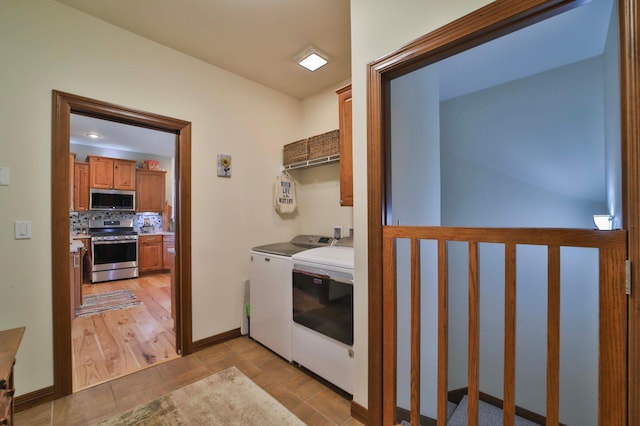 23369 330th St, Sebeka, MN 56477 - laundry room featuring washing machine and dryer, baseboards, and cabinet space