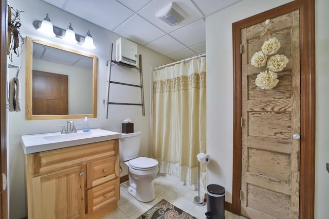23369 330th St, Sebeka, MN 56477 - bathroom with a drop ceiling, vanity, toilet, a shower with curtain, and tile patterned floors
