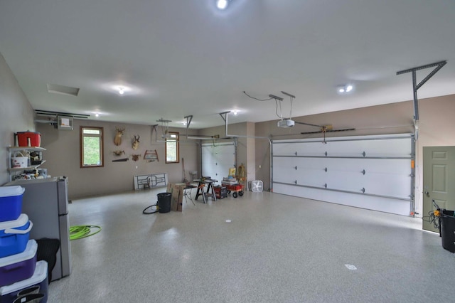 23369 330th St, Sebeka, MN 56477 - garage featuring freestanding refrigerator and a garage door opener