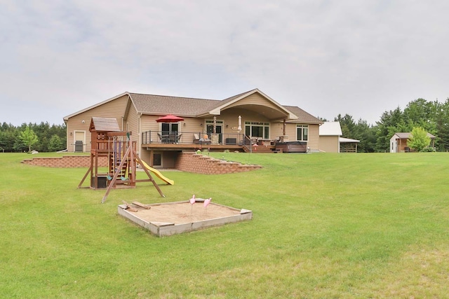 23369 330th St, Sebeka, MN 56477 - back of house featuring a wooden deck, a yard, and a playground