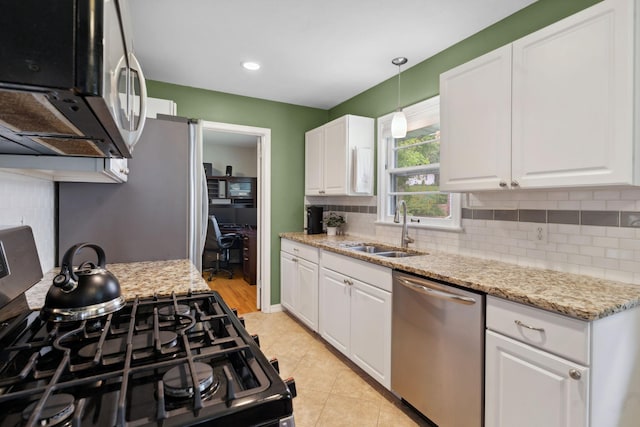 3732 Jersey Ave N, Crystal, MN 55427 - kitchen featuring appliances with stainless steel finishes, tasteful backsplash, white cabinets, decorative light fixtures, and light stone countertops