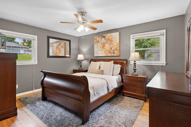 3732 Jersey Ave N, Crystal, MN 55427 - bedroom featuring multiple windows, light wood finished floors, and ceiling fan