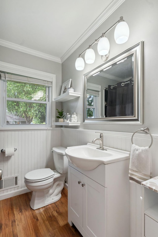 3732 Jersey Ave N, Crystal, MN 55427 - bathroom with vanity, wainscoting, crown molding, wood finished floors, and plenty of natural light