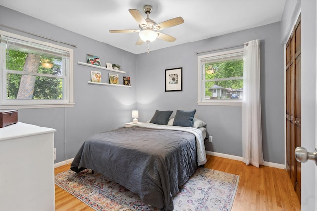 3732 Jersey Ave N, Crystal, MN 55427 - bedroom with multiple windows, light wood-type flooring, and a ceiling fan