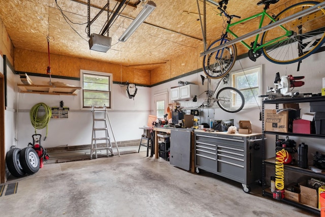 3732 Jersey Ave N, Crystal, MN 55427 - garage with a workshop area and a garage door opener