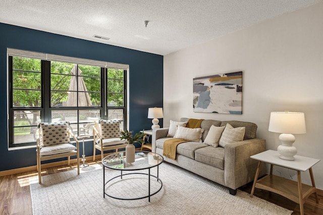 2566 Ellis Ave Unit 124, Saint Paul, MN 55114 - living room with wood finished floors, a textured ceiling, and baseboards