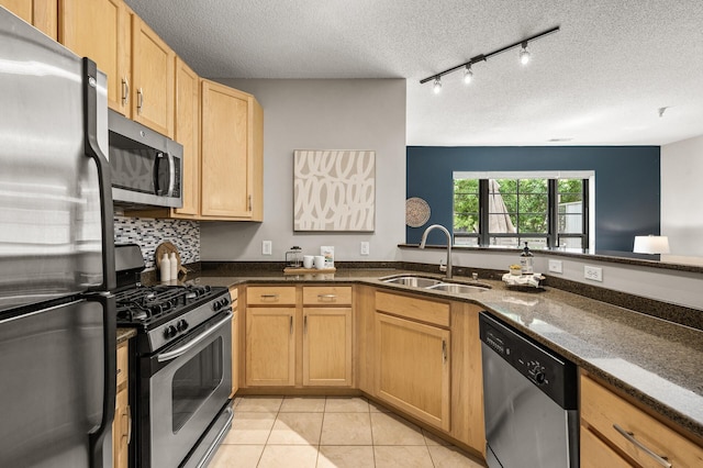 2566 Ellis Ave Unit 124, Saint Paul, MN 55114 - kitchen featuring appliances with stainless steel finishes, a sink, a textured ceiling, dark stone counters, and light tile patterned flooring