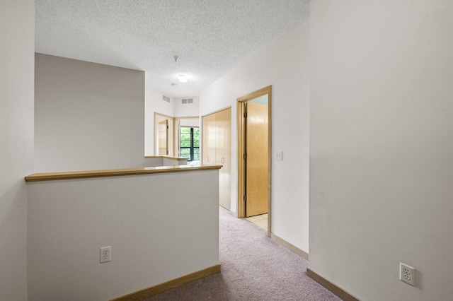 2566 Ellis Ave Unit 124, Saint Paul, MN 55114 - corridor featuring carpet flooring, a textured ceiling, and baseboards