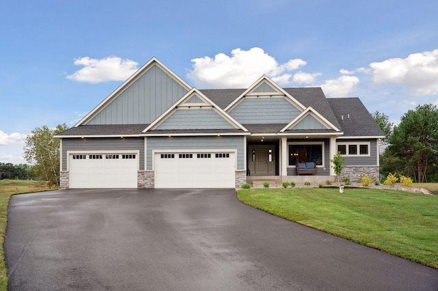 18022 Urbank St NE, Ham Lake, MN 55304 - craftsman-style house featuring stone siding, a front yard, driveway, and a garage