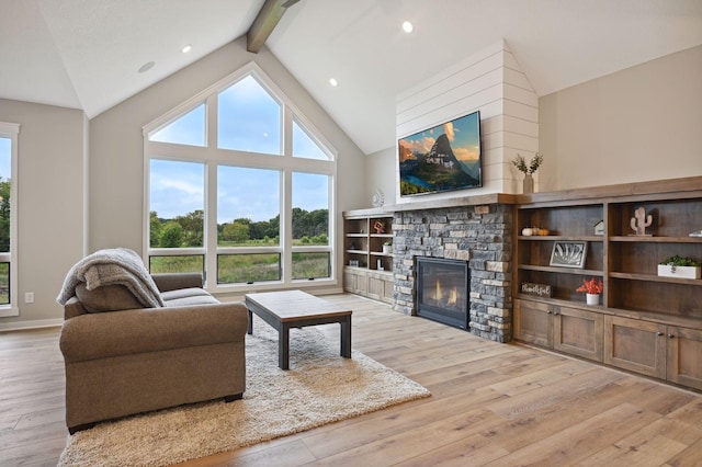 18022 Urbank St NE, Ham Lake, MN 55304 - living room with healthy amount of natural light, a fireplace, beam ceiling, hardwood / wood-style floors, and high vaulted ceiling