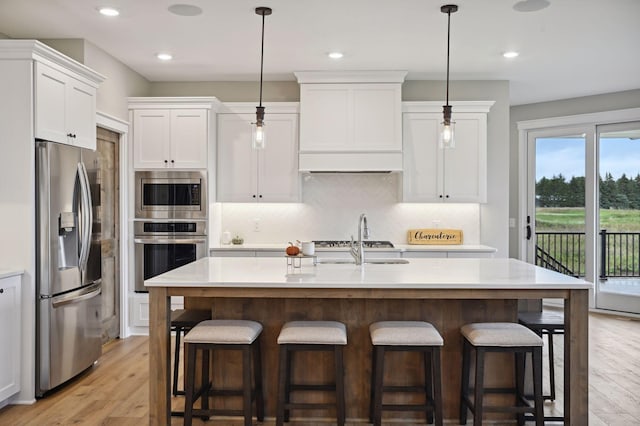 18022 Urbank St NE, Ham Lake, MN 55304 - kitchen featuring stainless steel appliances, light countertops, light wood-style floors, white cabinets, and recessed lighting