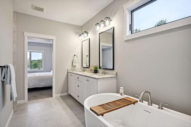 18022 Urbank St NE, Ham Lake, MN 55304 - bathroom with double vanity, a soaking tub, ensuite bath, and baseboards