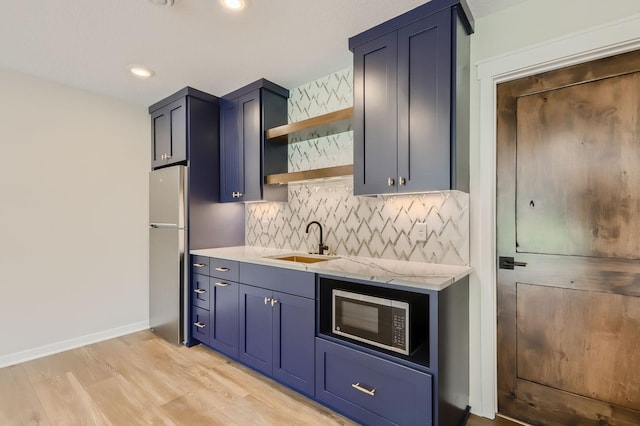 18022 Urbank St NE, Ham Lake, MN 55304 - kitchen with a sink, built in microwave, open shelves, light wood-style floors, and tasteful backsplash