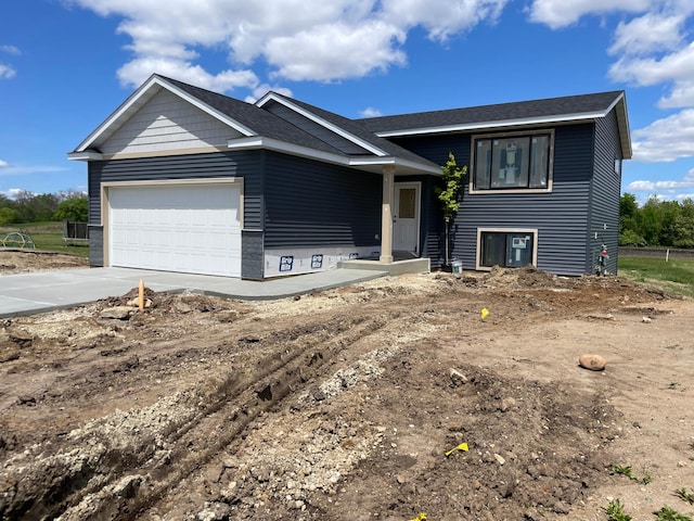 921 3rd St Unit E, Wanamingo, MN 55983 - view of front of property featuring an attached garage, concrete driveway, and roof with shingles