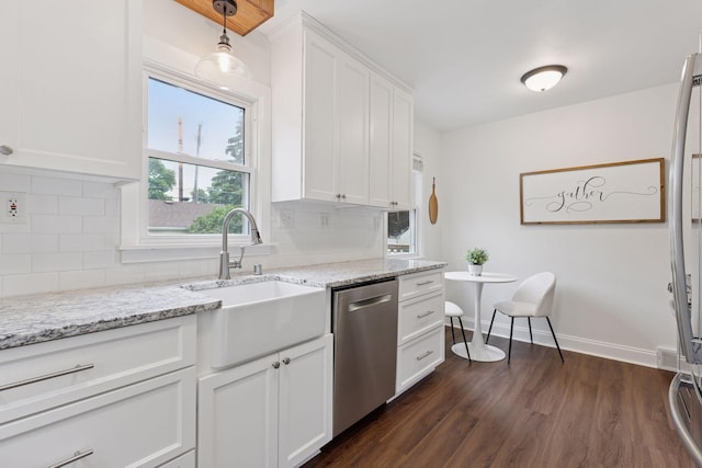 2904 Jersey Ave S, Saint Louis Park, MN 55426 - kitchen featuring stainless steel dishwasher, dark wood-type flooring, white cabinets, tasteful backsplash, and light stone counters