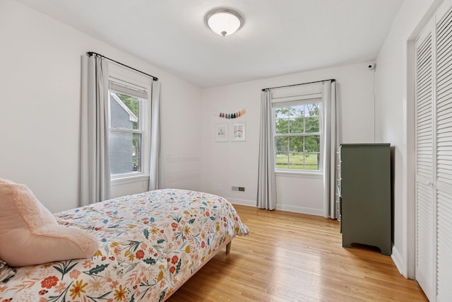 2904 Jersey Ave S, Saint Louis Park, MN 55426 - bedroom featuring multiple windows and light wood-style flooring