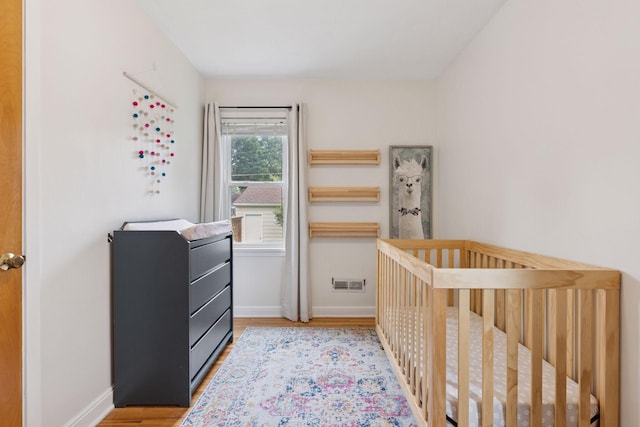 2904 Jersey Ave S, Saint Louis Park, MN 55426 - bedroom with wood finished floors and a nursery area