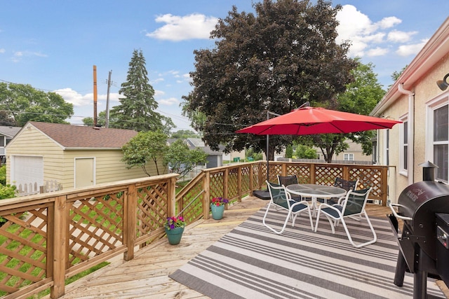 2904 Jersey Ave S, Saint Louis Park, MN 55426 - wooden deck with outdoor dining space, grilling area, and a detached garage
