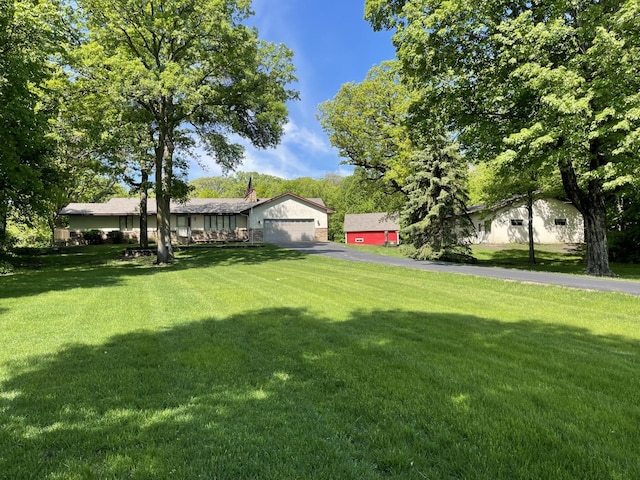 8048 Lake Ida Way NW, Alexandria, MN 56308 - view of grassy yard with asphalt driveway and an attached garage