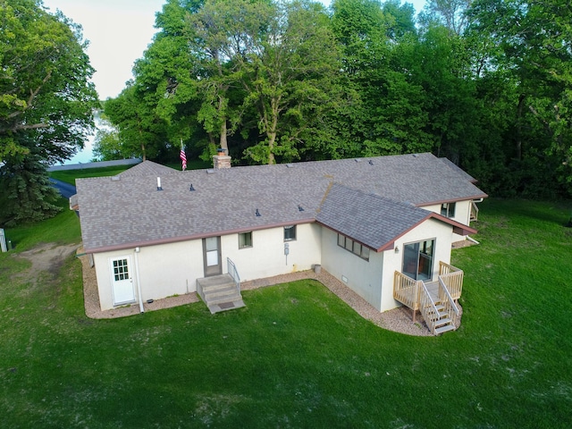 8048 Lake Ida Way NW, Alexandria, MN 56308 - rear view of property featuring stucco siding, a shingled roof, a yard, and a chimney