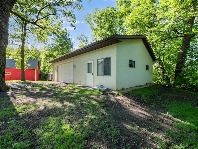 8048 Lake Ida Way NW, Alexandria, MN 56308 - rear view of property featuring stucco siding and a garage