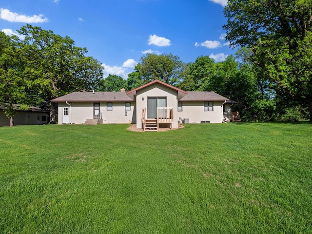 8048 Lake Ida Way NW, Alexandria, MN 56308 - back of house featuring stucco siding and a yard