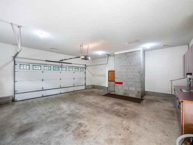8048 Lake Ida Way NW, Alexandria, MN 56308 - garage featuring a sink and a garage door opener