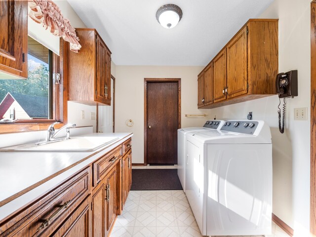 8048 Lake Ida Way NW, Alexandria, MN 56308 - washroom with washing machine and clothes dryer, cabinet space, light floors, and baseboards