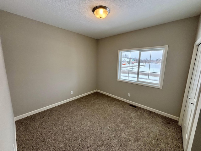 11798 5th St NE, Hanover, MN 55341 - unfurnished room with dark colored carpet, baseboards, and a textured ceiling