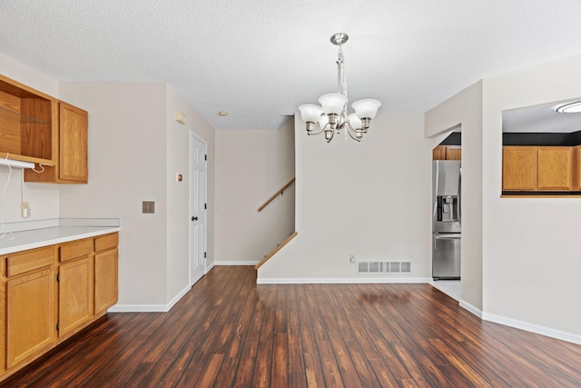 7719 Nicholas Way, Chanhassen, MN 55317 - kitchen with stainless steel fridge, dark wood-style floors, a chandelier, open shelves, and light countertops