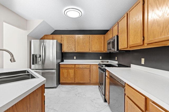 7719 Nicholas Way, Chanhassen, MN 55317 - kitchen featuring appliances with stainless steel finishes, light marble finish floors, a sink, and light countertops