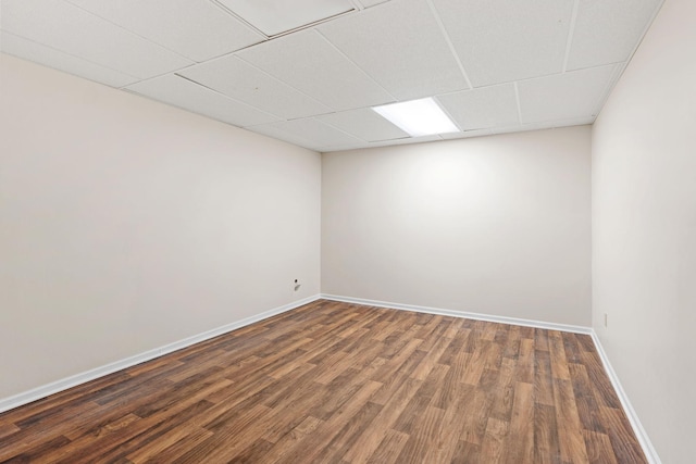 7719 Nicholas Way, Chanhassen, MN 55317 - empty room with dark wood finished floors, baseboards, and a drop ceiling