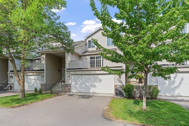 7719 Nicholas Way, Chanhassen, MN 55317 - view of front facade featuring asphalt driveway, a garage, and central AC