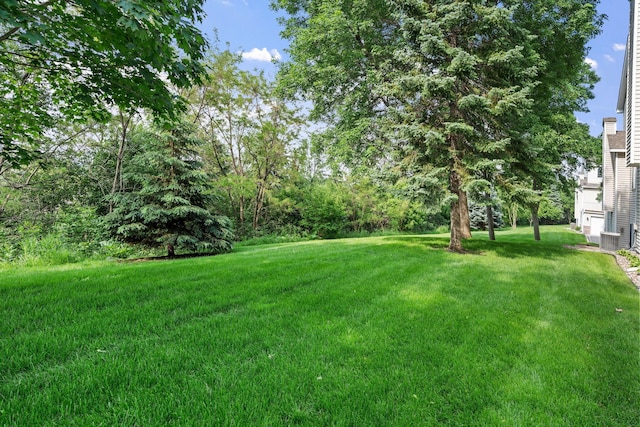 7719 Nicholas Way, Chanhassen, MN 55317 - view of grassy yard with cooling unit