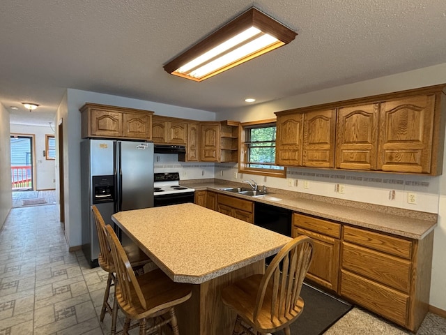23759 Clarissa Haven Dr, Girard Twp, MN 56551 - kitchen featuring stainless steel fridge with ice dispenser, electric range oven, brown cabinetry, a kitchen island, and dishwasher