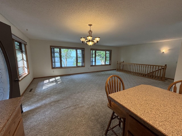 23759 Clarissa Haven Dr, Girard Twp, MN 56551 - carpeted dining space with a chandelier, a textured ceiling, and baseboards