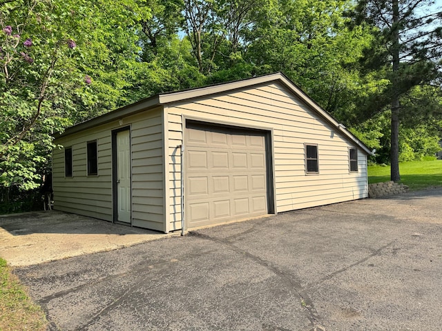 23759 Clarissa Haven Dr, Girard Twp, MN 56551 - detached garage featuring driveway and view of scattered trees