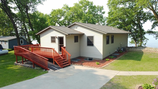 23759 Clarissa Haven Dr, Girard Twp, MN 56551 - bungalow featuring a wooden deck, a front lawn, roof with shingles, and central air condition unit