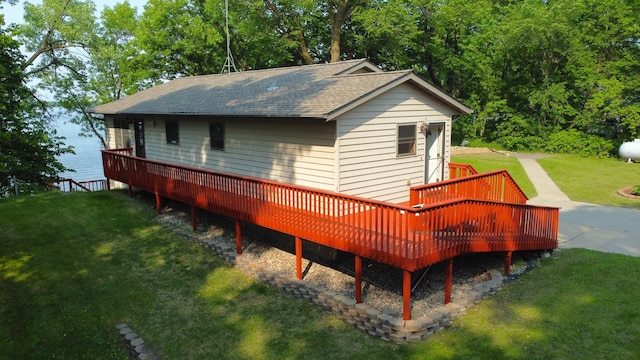 23759 Clarissa Haven Dr, Girard Twp, MN 56551 - back of house featuring a deck, a shingled roof, and a lawn