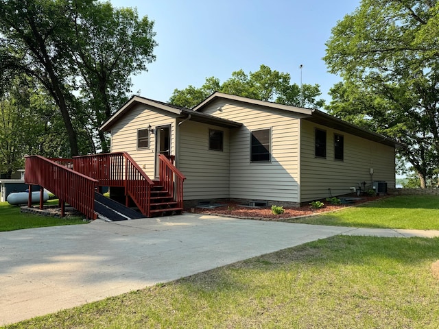 23759 Clarissa Haven Dr, Girard Twp, MN 56551 - view of front of home with a front lawn, central AC unit, and a deck