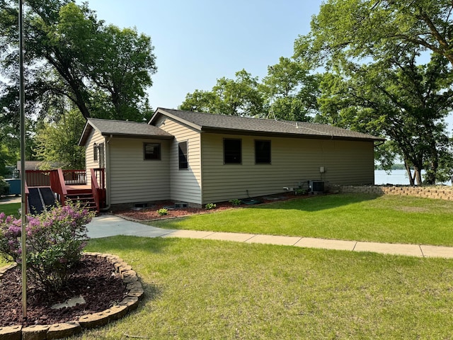 23759 Clarissa Haven Dr, Girard Twp, MN 56551 - view of side of property featuring a wooden deck, central AC unit, a lawn, crawl space, and a shingled roof