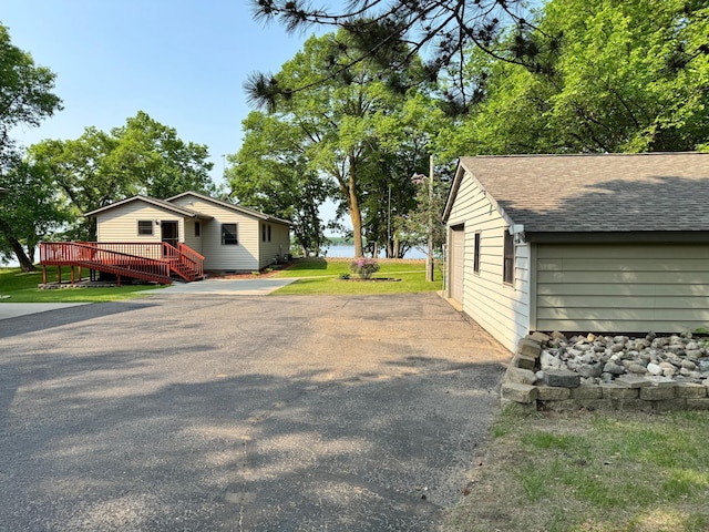 23759 Clarissa Haven Dr, Girard Twp, MN 56551 - view of side of property with a wooden deck and a shingled roof